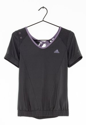 Black Adidas short-sleeve athletic top with purple trim, V-neck, back tie detail, and elastic waistband hanging on a black hanger.