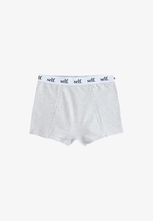 Hellgraue Boxershorts mit weißem elastischem Bund, der mit schwarzem „self.“-Text wiederholt bedruckt ist, flach auf weißem Hintergrund dargestellt.