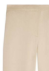 Jasno beżowe spodnie z gładkiego, teksturowanego materiału. Posiadają bezszwowy pas i minimalne detale szycia. Zaprojektowane bez kieszeni.