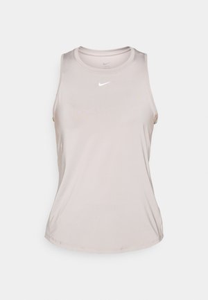 Débardeur de sport sans manches beige clair en tissu lisse, avec un col rond et un petit logo Nike blanc sur le devant.