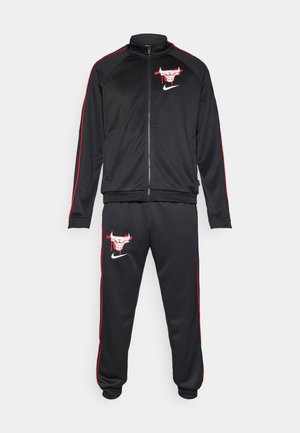 Black Nike tracksuit featuring a zippered jacket with red accents and a logo on the chest, complemented by matching pants with logo and accents.