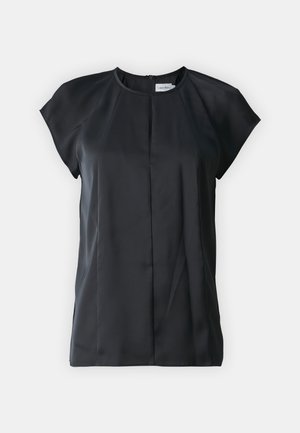 Black short-sleeve blouse made of smooth fabric, featuring a round neckline and vertical pleat detail at the front. Zipper closure at back.