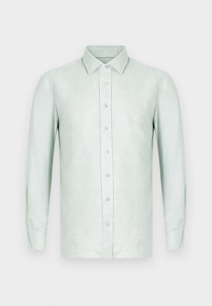 Hellgrünes Leinenhemd mit langen Ärmeln, vorne mit Knöpfen, Kragen und einem dezenten Logo auf der linken Brustseite.
