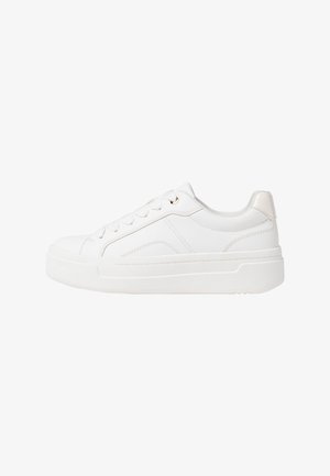White sneakers with a smooth leather upper, flat laces, and a rubber sole. Features subtle stitching and a small metallic accent.