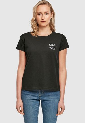 Black cotton t-shirt with a relaxed fit, short sleeves, and a round neckline. "STAY WILD" printed in white on the left chest area.