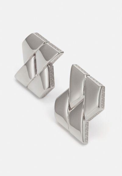 Silver cufflinks with a geometric design, featuring a polished finish and etched border. Shapes interlock at angles for a 3D effect.