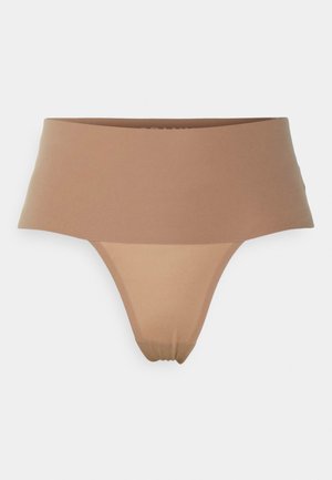 Nude-colored thong with a wide, smooth waistband and soft, stretchy material. Features a minimalistic design with no visible seams.