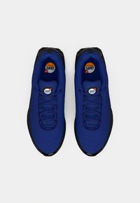 Blue Nike Air Max sneakers with a smooth textile upper, black rubber outsole, and textured laces. Circular logo on the insole.