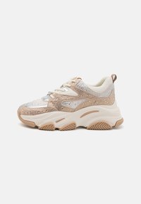 Tugevad sneakerid heledad beežidest ja hõbedast tekstuuridest, millel on rhinestone aksessuaarid, kreemjas kandetapp ja mustriga kummitald.