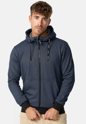 Dark blue zip-up hoodie with a textured finish, gray lining, adjustable hood, front pockets, and black ribbed cuffs and hem.