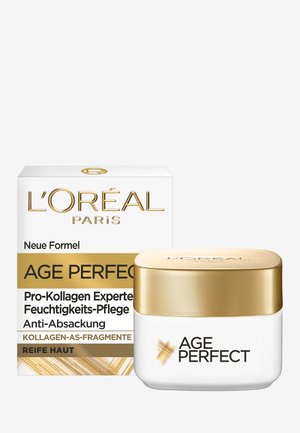 Witte pot met een gouden deksel gelabeld "AGE PERFECT." Vergezeld door een witte doos met gouden tekst en een geometrisch ontwerp.