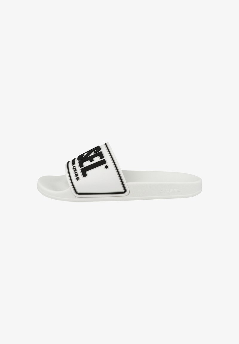 White slide sandal with a wide strap featuring a black logo. Smooth rubber material, minimalist design, and a flat sole.
