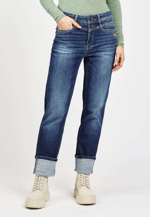 Dark blue denim jeans with a straight-leg cut, rolled cuffs, and two-button waistband. Features visible stitching and back pockets.