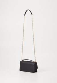 Black leather handbag with a structured design, featuring a top handle and a gold chain shoulder strap. Smooth texture and minimal detailing.
