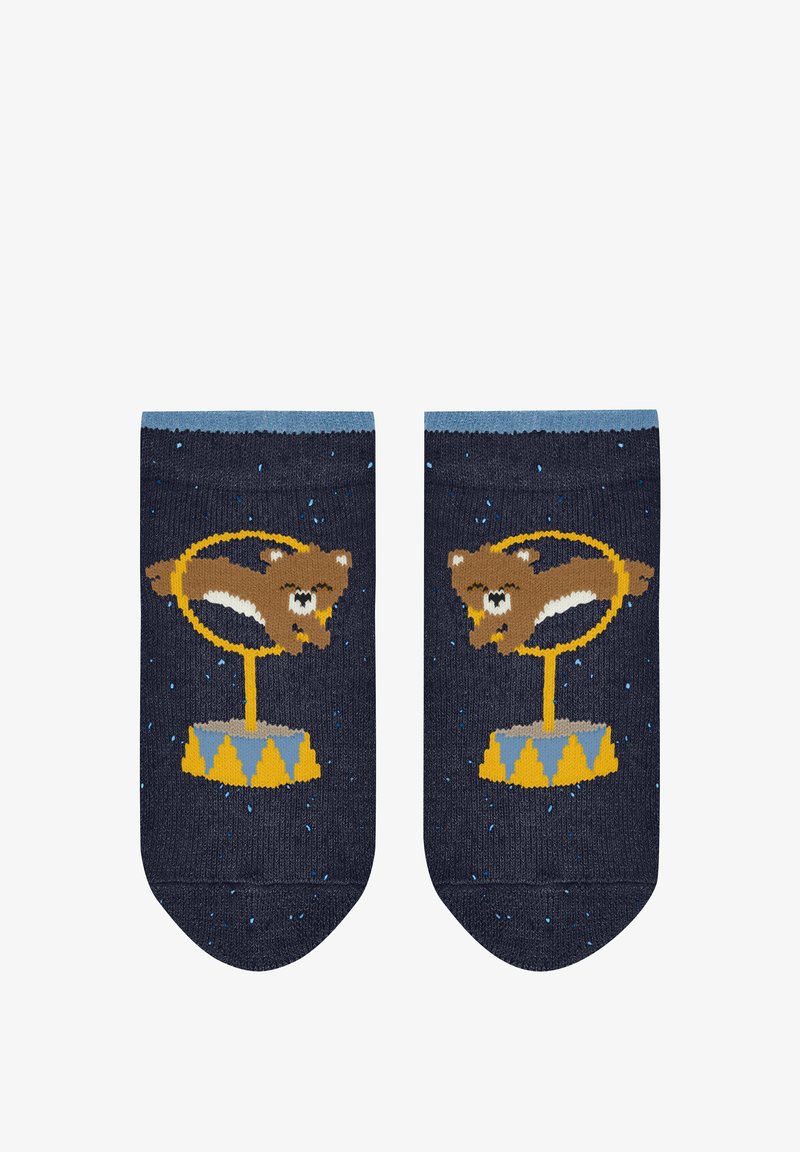 Strumpf stricken in Marineblau mit hellblauen Bündchen. Beinhaltet ein braunes Tier auf einem gelben Zirkushintergrund, mit Sternen und bunten Akzenten.