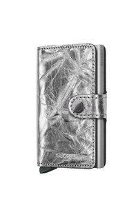 Silver metallic wallet featuring a textured leather exterior, snap closure, and a prominent brand logo. Compact and rectangular shape.