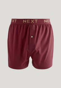 Bordeauxfarbene Boxershorts aus weichem Stoff, mit einer Knopfleiste, einem elastischen Bund mit goldenem "NEXT"-Logo und flachen Nähten.
