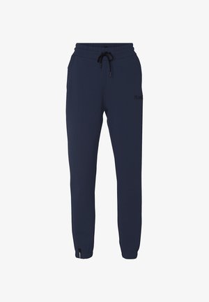 Marineblå sweatpants lavet af blødt stof, med elastisk talje og snøre, sidelommer og indsnrækkede manchetter ved anklerne.