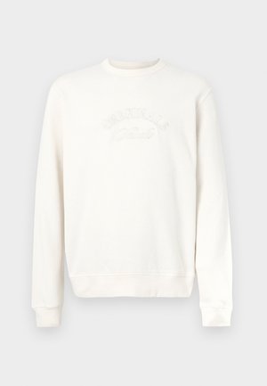 Sweatshirt en coton couleur écrue avec un col rond côtelé, des manches longues et un texte brodé "ORIGINALS" sur le devant. Texture lisse.