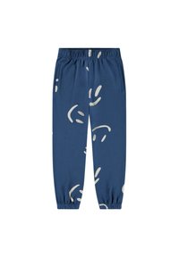 Sininen verkkarit, valmistettu puuvillasta, joissa on valkoinen abstrakti kuvio, joustava vyötärö ja joustavat hihnat nilkoissa.