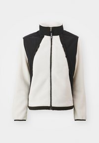 Kurtka polarowa z wysokim kołnierzem; biały korpus i czarne ramiona; posiada kieszenie na zamek i elastyczne mankiety; gładka i miękka tekstura.