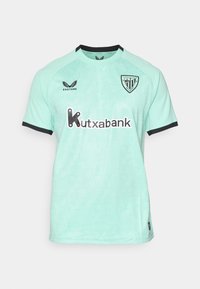 Helles türkisfarbenes Fußballtrikot des Athletic Club Bilbao mit schwarzem Besatz, Castore-Logo und Kutxabank-Sponsor auf der Vorderseite.