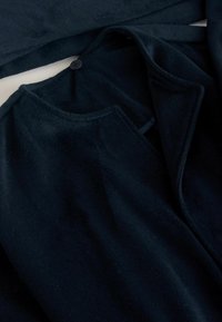 Dark navy wool coat with a single black button near the collar, displayed flat with the lapel folded open.