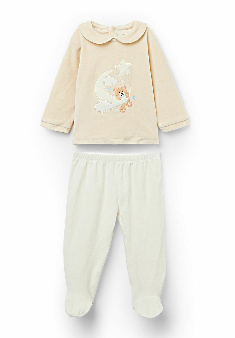 Beżowa bluzka z długim rękawem i okrągłym kołnierzem, z haftowanym misiem, księżycem i gwiazdami; zestawiona z kremowymi spodniami z detalem przy stopach.