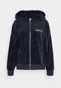 Sweat à capuche zippé en peluche bleu marine avec poches avant, capuche à cordon, poignets côtelés et "LEVI'S" brodé en or sur la poitrine.