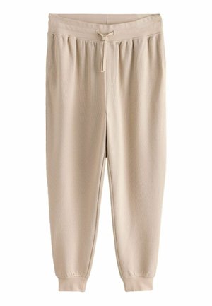 Beige fleece joggerbyxor med elastisk midja, dragsko, sidofickor och ribbade muddars. Mjuk textur och avslappnad passform.