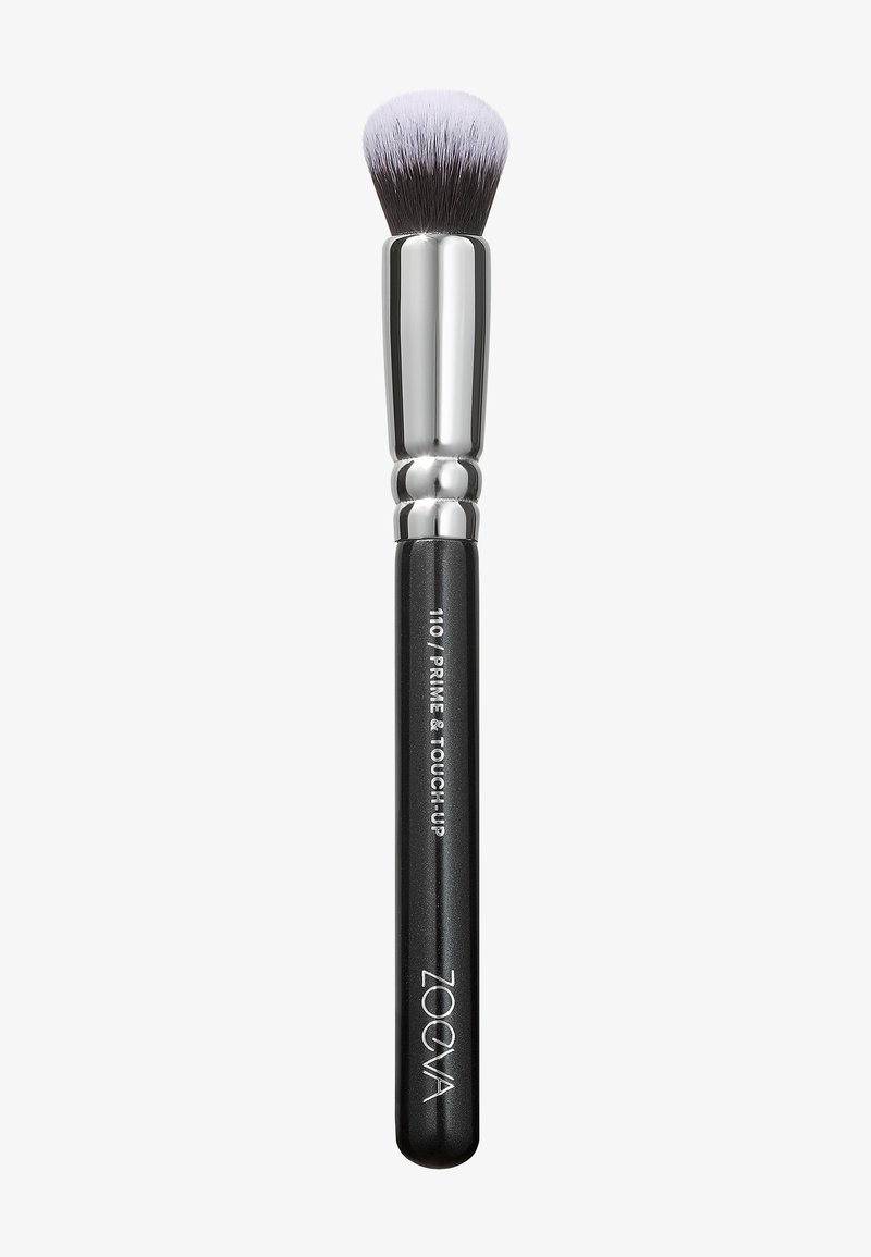 Pennello da trucco nero con una testa arrotondata e setole dense. Il ferretto argento collega la testa a un manico nero opaco, con testo in rilievo e logo.