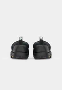 Black footwear with a thick sole and rubber tread. Features a cushioned upper and pull tabs at the back for easy wear. Lightweight design.