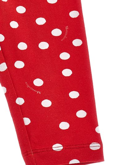 Leggings rojos con un patrón de lunares blancos, fabricados en un tejido suave y elástico con una textura lisa y dobladillo cosido.