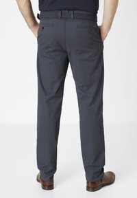 Dark navy trousers made of smooth fabric, featuring a flat front, two back pockets with buttons, and a braided belt. Brown shoes complete the look.