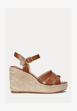 Brown leather wedge sandals with braided jute detailing, adjustable ankle strap, and multiple crossed straps on the toe for support.