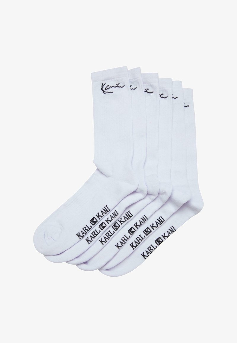 Baltas kokvilnas zeķes ar melnu logotipu "Kani" uz potītes un ar "KARL KANI" drukātu netālu no pirksta. Sešas pāri redzami kaudzē.