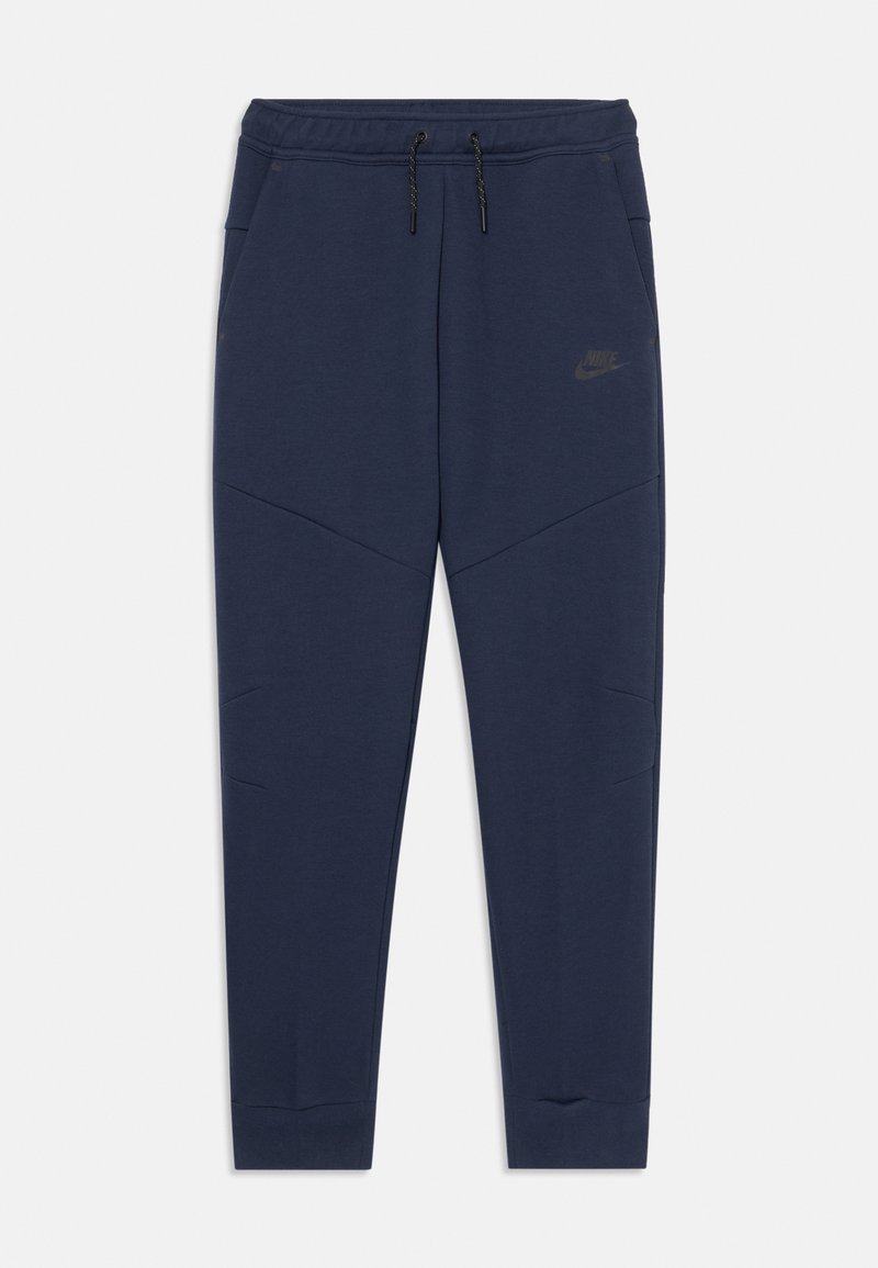 Calças de moletão azul-marinho da Nike com cintura elástica e cordão, pernas ajustadas e costuras angulares. Apresenta um logotipo subtil na coxa esquerda.