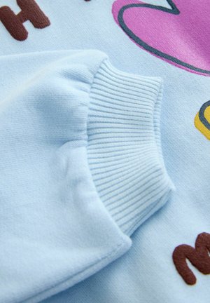 Svetlomodrá mikina s rebrovaným manžetom a hravým viacfarebným textovým potlačou, s hladkou textúrou a žiarivými akcentmi.