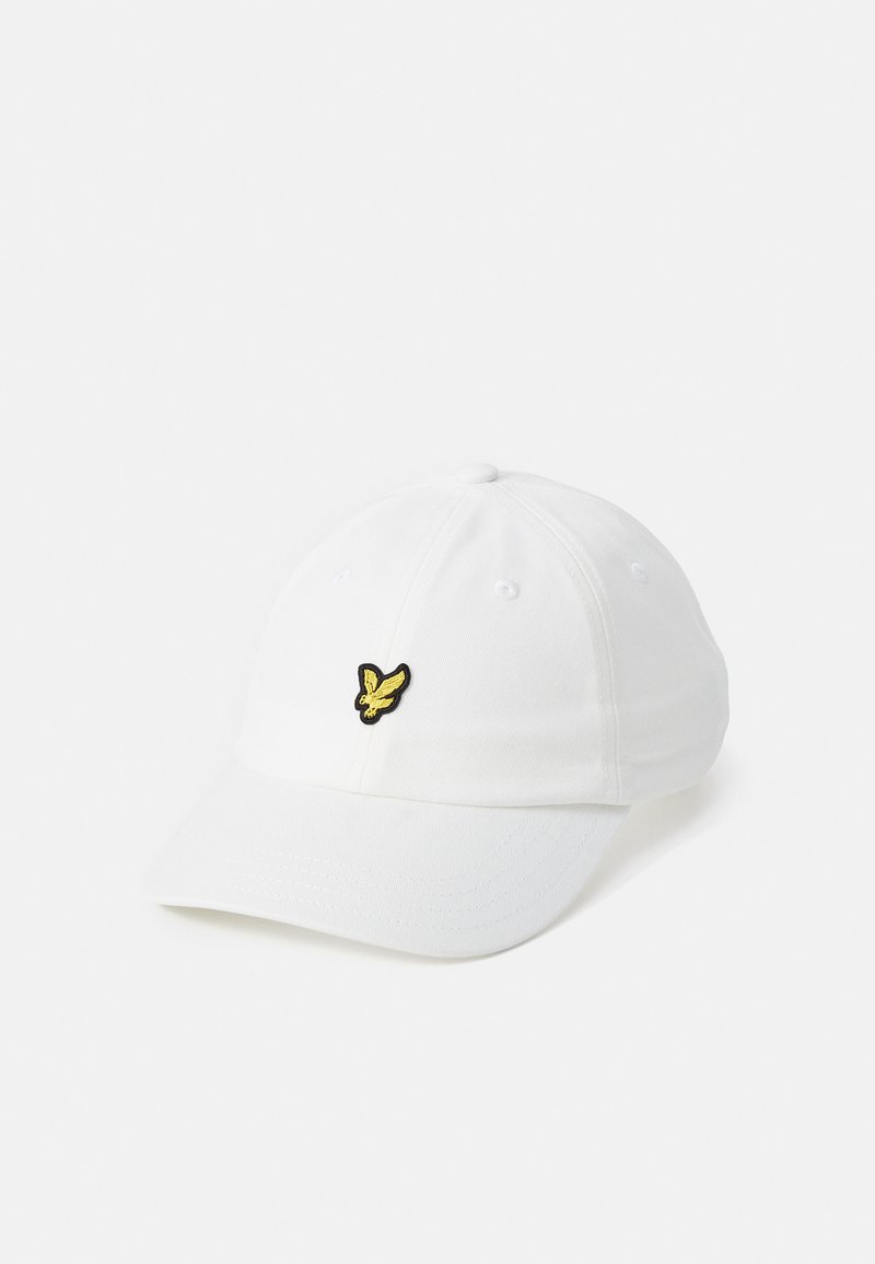 White baseball cap made of cotton, featuring a black and yellow embroidered logo on the front, with a curved brim and ventilation holes.
