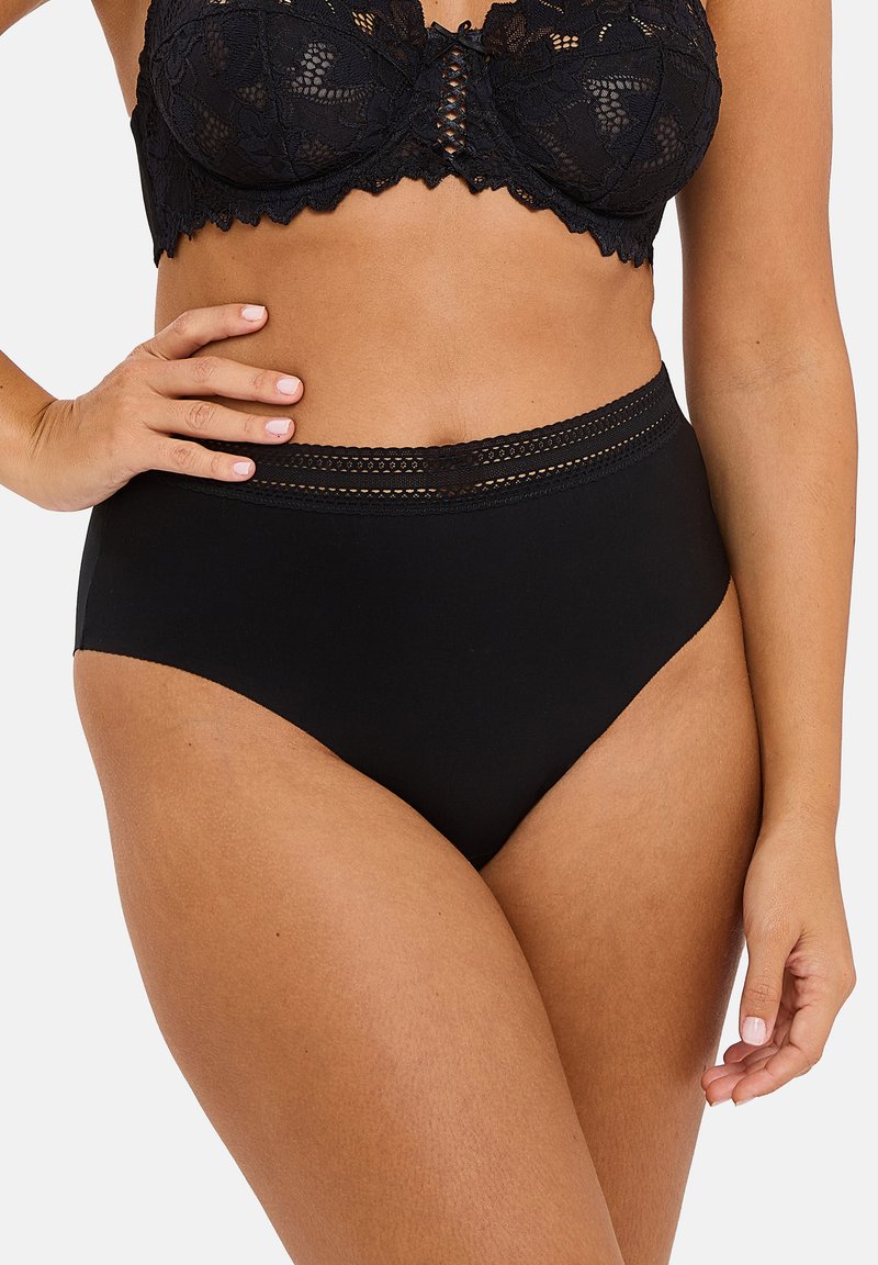 Black lace bralette with a scalloped edge and structured cups, paired with high-waisted black briefs featuring a lace-accented waistband.