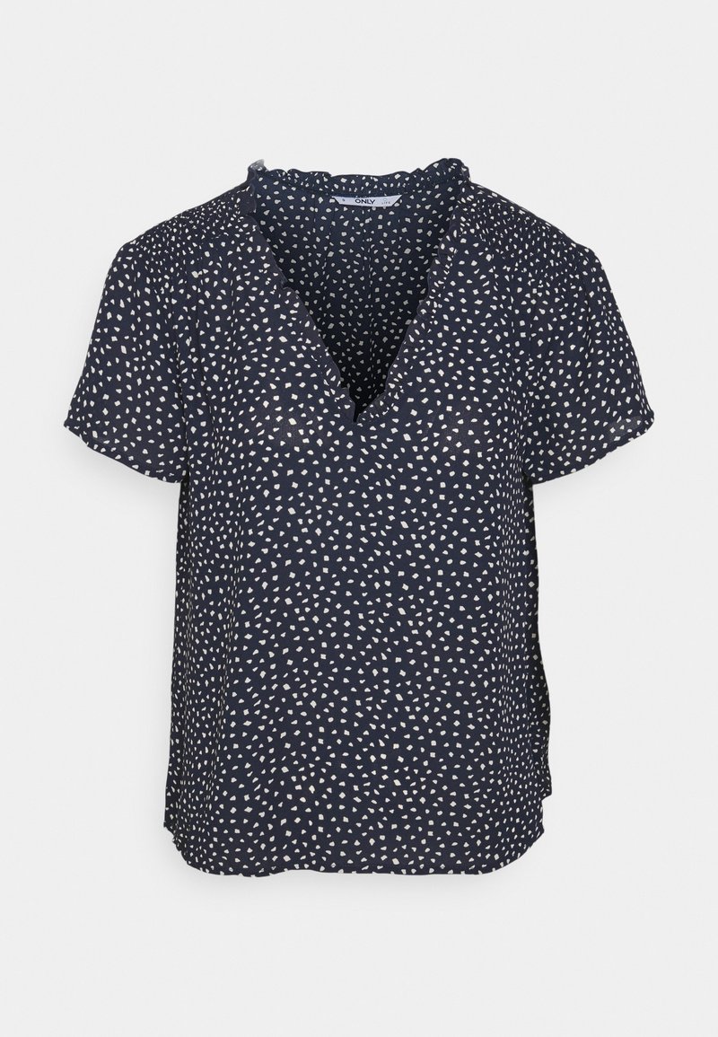 Blouse bleu marine à manches courtes avec de petites formes géométriques blanches dispersées, encolure en V et léger détail de volants au col.