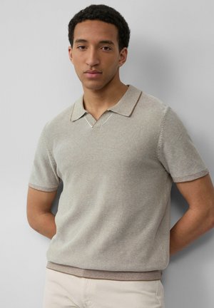 Beige polo shirt met korte mouwen en een v-hals, voorzien van dunne horizontale strepen en contrasterende afwerking op de kraag en onderrand. Soepele textuur.