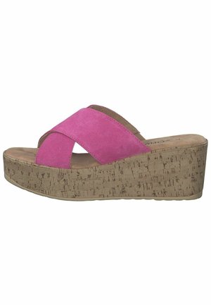 Pink suede wedge sandals with a cork platform. Features a crossed strap design and a smooth insole texture.