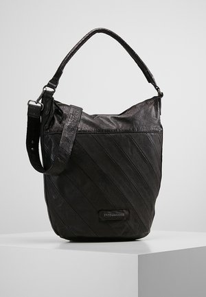 Black leather bucket bag with diagonal stitching, adjustable shoulder strap, and "FredsBruder" label on front, displayed on white surface.