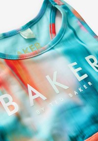 Multifarvet sportstop med et gradientdesign i blå, pink og orange nuancer. "BAKER by TED BAKER" logo i hvid, glat tekstur.