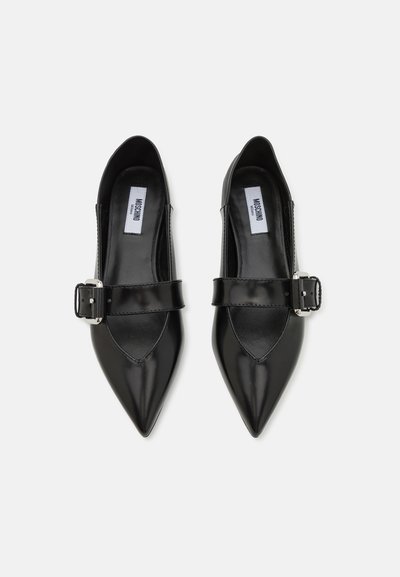 Black leather shoes featuring a pointed toe design, a low-cut vamp, and a strap with a silver buckle across the instep.
