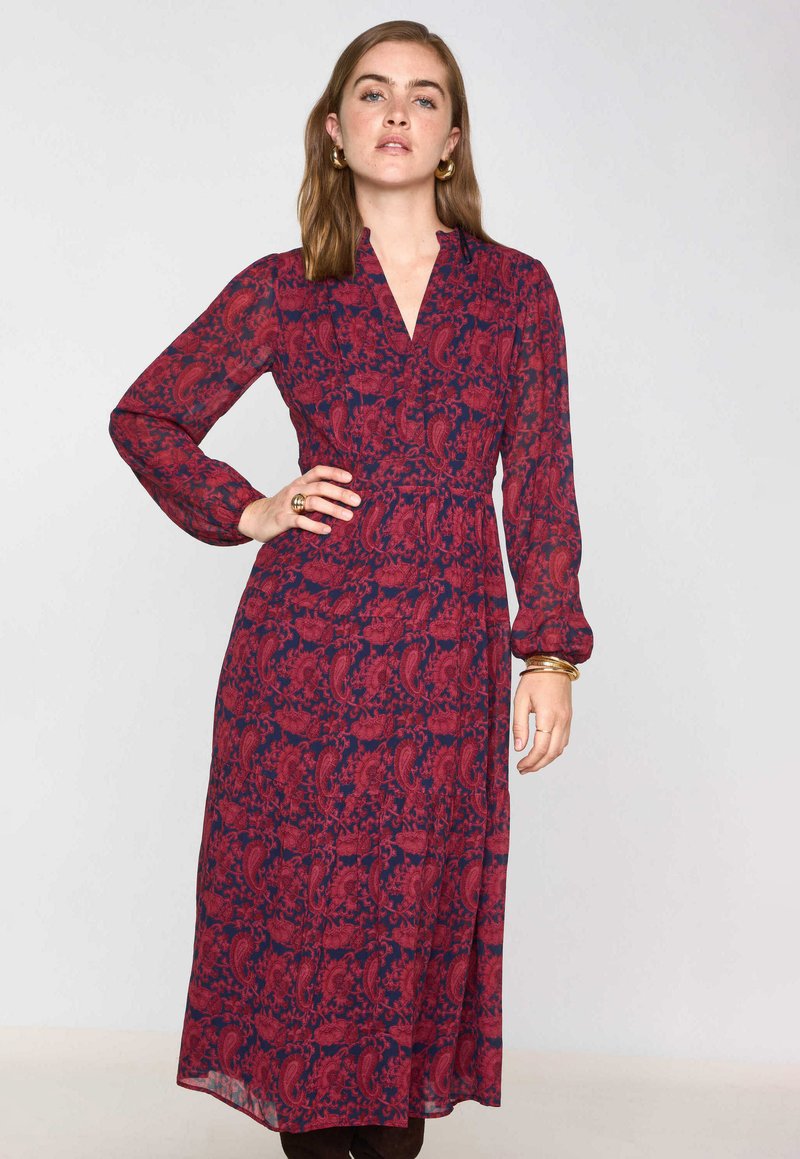 Abito lungo, con bottoni, in blu navy scuro e borgogna con motivo paisley, maniche lunghe e vita aderente, realizzato in tessuto leggero.