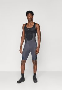 Mustad mustrid jalgrattapüksid, millel on võrknahk, pehmendusega iste, sobiv disain ja logode aktsendid jalgadel.