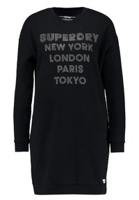 Černé šaty z měkkého materiálu, s kulatým výstřihem, dlouhými rukávy a textem z kamínků: "SUPERDRY NEW YORK LONDÝN PAŘÍŽ TOKIO."