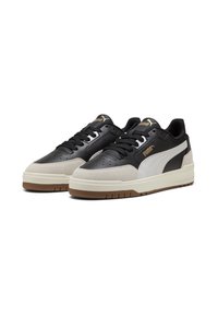 Black and gray sneakers with a leather and suede upper, featuring a white stripe, textured accents, and a rubber outsole.